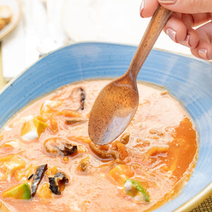 brown spoon made from agave being used with soup