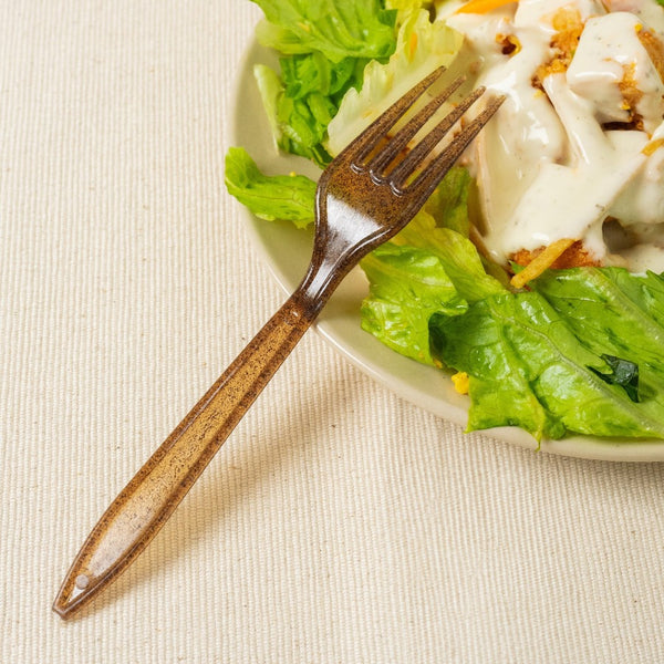 brown fork made from agave being used with salad