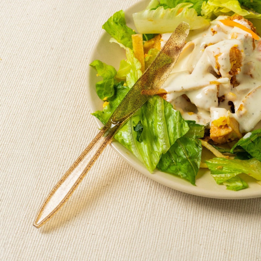 brown knife made from agave being used with salad